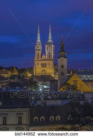 Stock Image - Cathedral spires over rooftops in cityscape, Zagreb, Zagreb, Croatia. Fotosearch