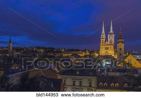 Stock Image - Cathedral spires over rooftops in cityscape, Zagreb, Zagreb, Croatia. Fotosearch