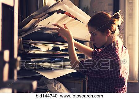 Caucasian artist sorting through papers in studio View Large Photo Image Stock Image - Caucasian artist sorting through papers in studio. Fotosearch
