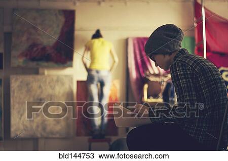 Caucasian artists working in studio View Large Photo Image Stock Image - Caucasian artists working in studio. Fotosearch
