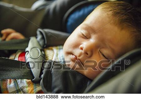 Caucasian baby boy sleeping in car seat View Large Photo Image Stock Photo - Caucasian baby boy sleeping in car seat. Fotosearch