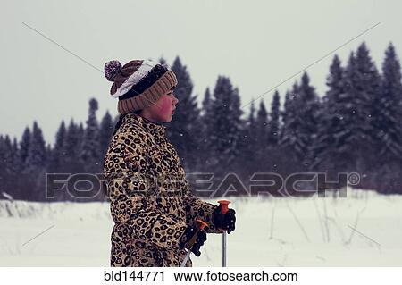 Stock Image - Caucasian boy cross-country skiing in snowy landscape. Fotosearch