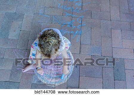Caucasian boy drawing with chalk on patio View Large Photo Image Stock Photo - Caucasian boy drawing with chalk on patio. Fotosearch