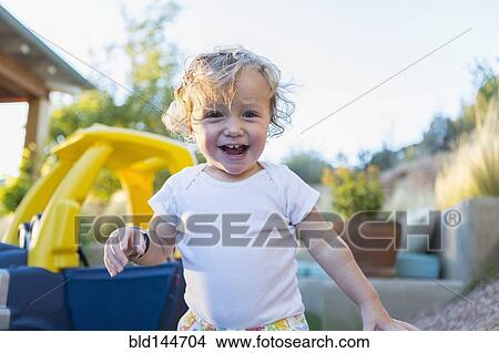 Picture - Caucasian boy laughing in backyard. Fotosearch