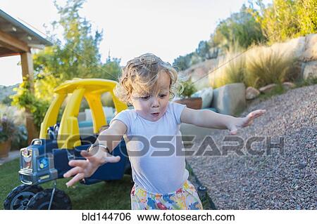 Caucasian boy playing in backyard View Large Photo Image Stock Photograph - Caucasian boy playing in backyard. Fotosearch