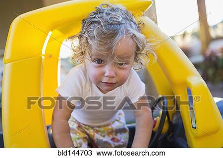 Caucasian boy playing in toy car View Large Photo Image Stock Image - Caucasian boy playing in toy car. Fotosearch