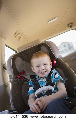 Caucasian boy smiling in car seat View Large Photo Image Stock Photograph - Caucasian boy smiling in car seat. Fotosearch