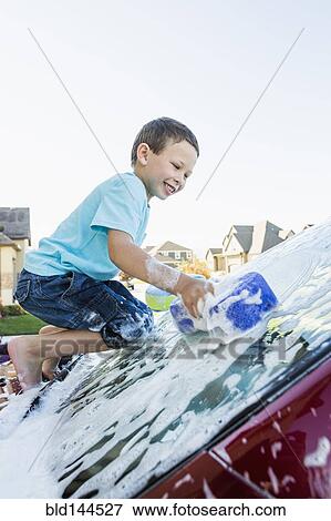 Caucasian boy washing car windshield View Large Photo Image Stock Photo - Caucasian boy washing car windshield. Fotosearch