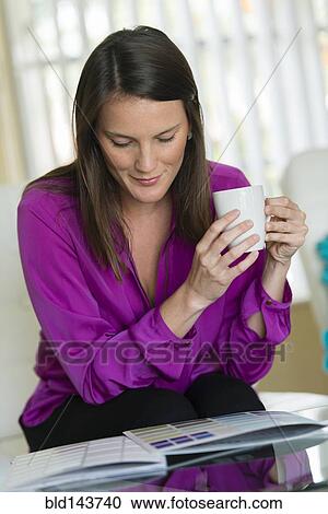 Stock Image - Caucasian businesswoman examining color swatches. Fotosearch