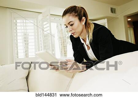 Caucasian businesswoman using digital tablet on sofa View Large Photo Image Stock Image - Caucasian businesswoman using digital tablet on sofa. Fotosearch