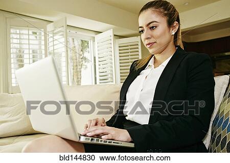 Caucasian businesswoman using laptop on sofa View Large Photo Image Stock Image - Caucasian businesswoman using laptop on sofa. Fotosearch