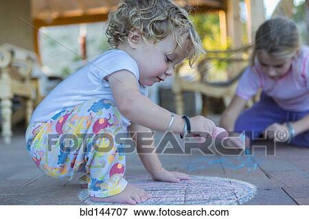 Caucasian children drawing with chalk on patio View Large Photo Image Stock Photo - Caucasian children drawing with chalk on patio. Fotosearch
