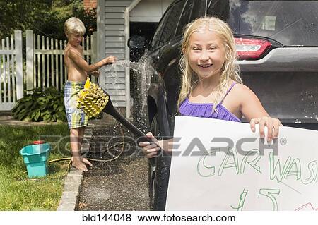 Stock Photo - Caucasian children having car wash in driveway. Fotosearch
