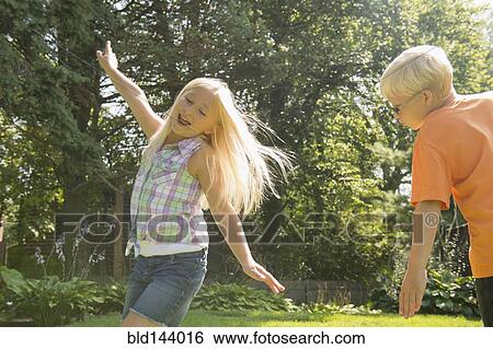 Caucasian children playing in backyard View Large Photo Image Stock Photograph - Caucasian children playing in backyard. Fotosearch