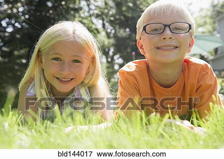 Caucasian children smiling in backyard View Large Photo Image Stock Photo - Caucasian children smiling in backyard. Fotosearch