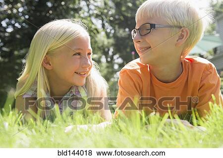 Stock Photo - Caucasian children smiling in backyard. Fotosearch