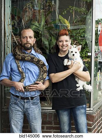 Caucasian couple holding pets outdoors View Large Photo Image Stock Photograph - Caucasian couple holding pets outdoors. Fotosearch