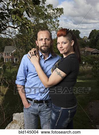 Caucasian couple hugging outdoors View Large Photo Image Picture - Caucasian couple hugging outdoors. Fotosearch