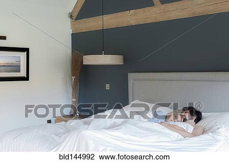 Caucasian couple laying in bed View Large Photo Image Stock Image - Caucasian couple laying in bed. Fotosearch