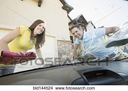 Caucasian couple washing car windshield View Large Photo Image Picture - Caucasian couple washing car windshield. Fotosearch