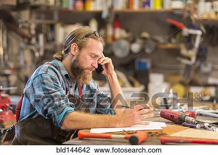 Caucasian craftsman working in workshop View Large Photo Image Stock Image - Caucasian craftsman working in workshop. Fotosearch