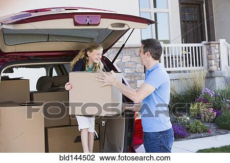 Caucasian family unpacking cardboard boxes from car View Large Photo Image Stock Image - Caucasian family unpacking cardboard boxes from car. Fotosearch