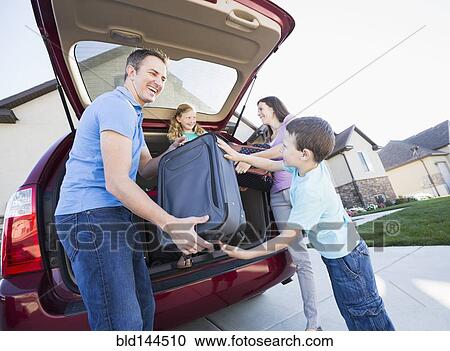 Caucasian family unpacking suitcases from car View Large Photo Image Stock Image - Caucasian family unpacking suitcases from car. Fotosearch