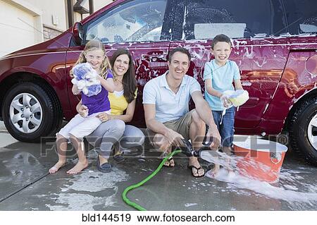 Caucasian family washing car in driveway View Large Photo Image Stock Photo - Caucasian family washing car in driveway. Fotosearch