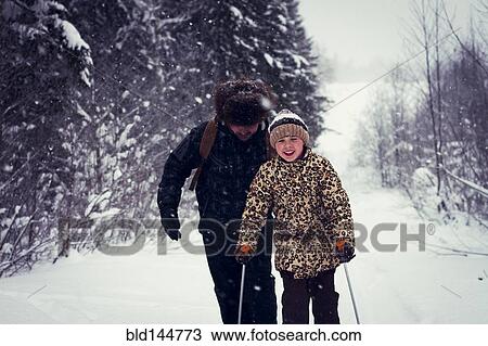 Caucasian father and daughter cross-country skiing on snowy road View Large Photo Image Stock Image - Caucasian father and daughter cross-country skiing on snowy road. Fotosearch