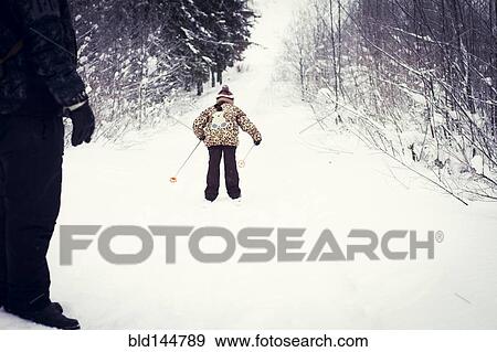 Caucasian father and daughter cross-country skiing on snowy road View Large Photo Image Stock Photo - Caucasian father and daughter cross-country skiing on snowy road. Fotosearch