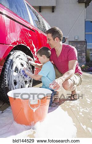 Caucasian father and son washing car in driveway View Large Photo Image Stock Photo - Caucasian father and son washing car in driveway. Fotosearch