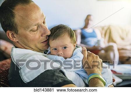 Caucasian father burping baby boy in living room View Large Photo Image Stock Image - Caucasian father burping baby boy in living room. Fotosearch