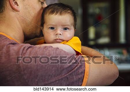 Caucasian father holding baby boy View Large Photo Image Picture - Caucasian father holding baby boy. Fotosearch