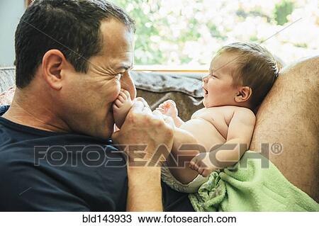 Caucasian father kissing feet of baby boy View Large Photo Image Stock Image - Caucasian father kissing feet of baby boy. Fotosearch