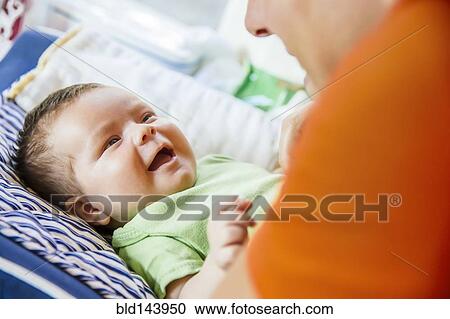 Caucasian father playing with baby boy View Large Photo Image Stock Image - Caucasian father playing with baby boy. Fotosearch