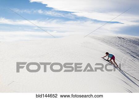 Caucasian girl climbing sand dune View Large Photo Image Stock Image - Caucasian girl climbing sand dune. Fotosearch