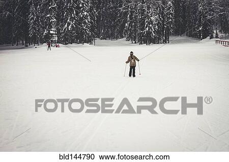 Caucasian girl cross-country skiing in snowy field View Large Photo Image Stock Image - Caucasian girl cross-country skiing in snowy field. Fotosearch