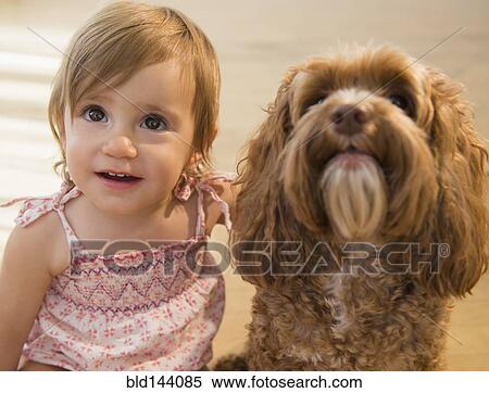 Stock Photography - Caucasian girl hugging pet dog. Fotosearch