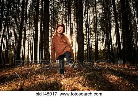 Stock Photo - Caucasian girl playing in forest. Fotosearch