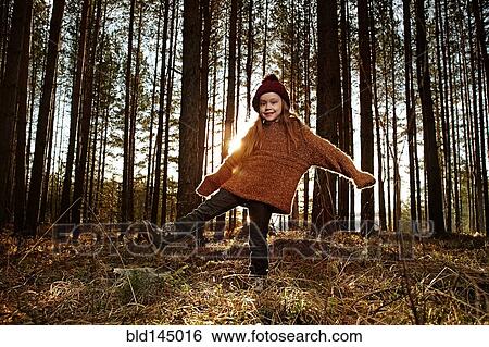 Caucasian girl standing in forest View Large Photo Image Stock Photograph - Caucasian girl standing in forest. Fotosearch