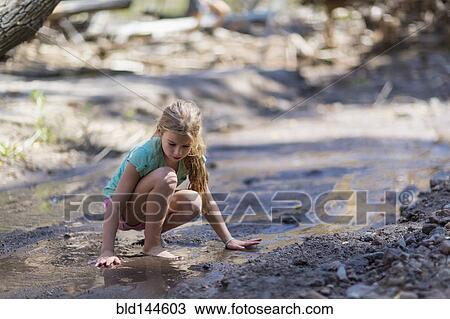Caucasian girls exploring creek in forest View Large Photo Image Stock Image - Caucasian girls exploring creek in forest. Fotosearch