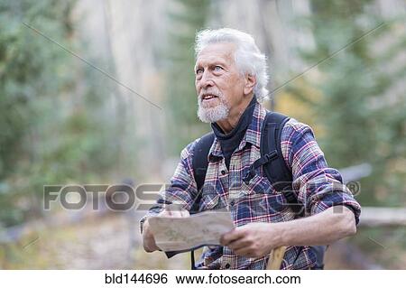Caucasian hiker reading map in forest View Large Photo Image Stock Photograph - Caucasian hiker reading map in forest. Fotosearch