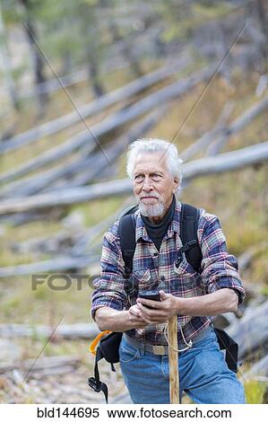Caucasian hiker using cell phone in forest View Large Photo Image Stock Photography - Caucasian hiker using cell phone in forest. Fotosearch