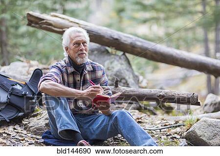 Caucasian hiker writing in forest View Large Photo Image Stock Image - Caucasian hiker writing in forest. Fotosearch