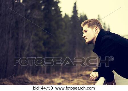Caucasian man admiring forest outdoors View Large Photo Image Stock Image - Caucasian man admiring forest outdoors. Fotosearch