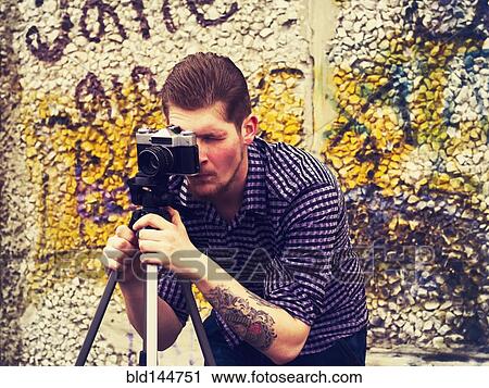 Caucasian man taking photograph outdoors View Large Photo Image Stock Image - Caucasian man taking photograph outdoors. Fotosearch