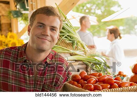 Caucasian man with produce at farmers market View Large Photo Image Stock Photograph - Caucasian man with produce at farmers market. Fotosearch