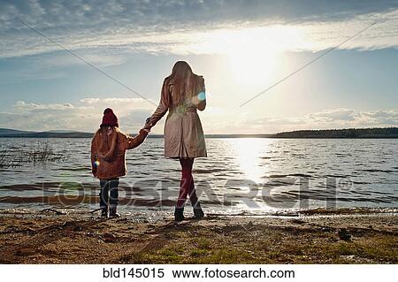 Caucasian mother and daughter standing on beach View Large Photo Image Stock Photography - Caucasian mother and daughter standing on beach. Fotosearch