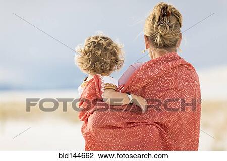 Caucasian mother and son wrapped in blanket on sand dune View Large Photo Image Stock Image - Caucasian mother and son wrapped in blanket on sand dune. Fotosearch