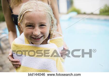 Caucasian mother drying daughter near swimming pool View Large Photo Image Stock Photograph - Caucasian mother drying daughter near swimming pool. Fotosearch